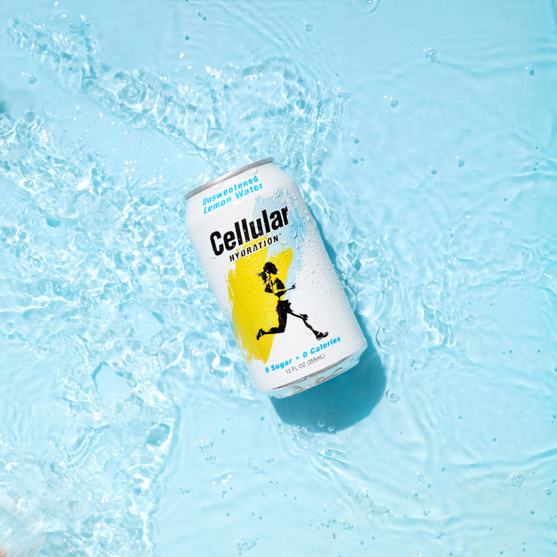 Can of Unsweetened Lemon Water Cellular Hydration in shallow water on blue background