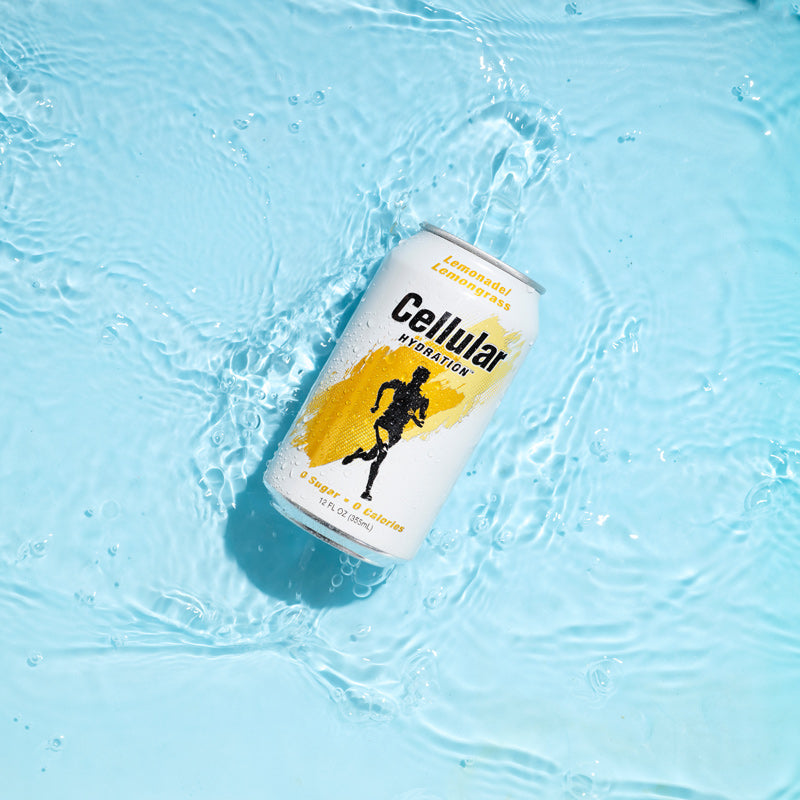 Can of Lemonade / Lemongrass Cellular Hydration in shallow water on blue background